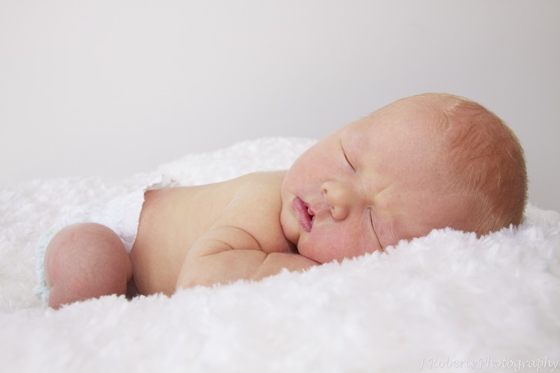 Snuggly newborn sleeping baby - newborn portrait photography